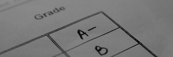 A minus grade written in black ink on a lined piece of paper