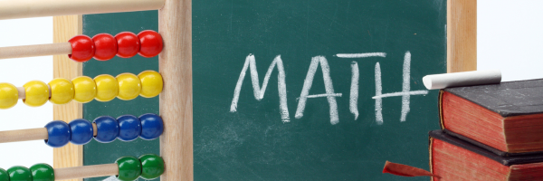 A colorful abacus sits next to a chalkboard with the word "MATH" written in chalk.