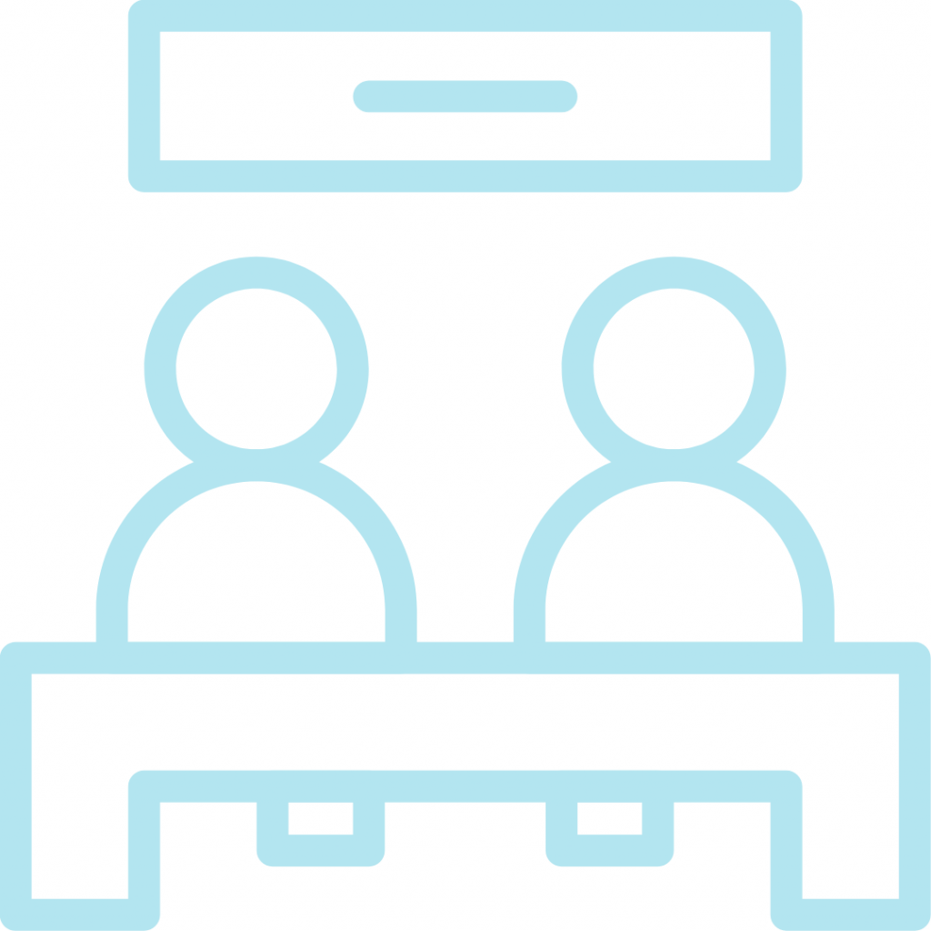 A line drawing of a table with two people sitting opposite each other. There is a rectangular object hanging above the table.
