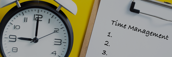Alarm clock and notepad with "Time Management" written on it, on a yellow background.
