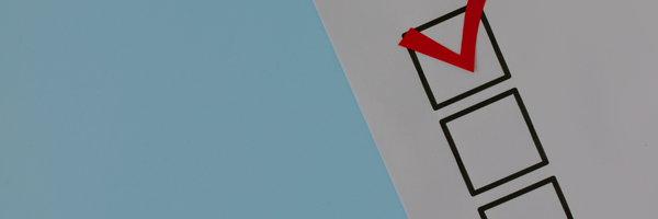 Checkmark in a box on a blue and white background.